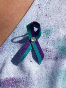 A green and purple looped ribbon. 